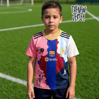 Child wearing kids football jersey and shorts set on soccer field
