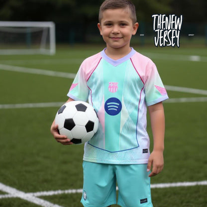 Child wearing kids football outfit holding a soccer ball on field
