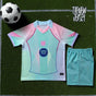 Kids football kit jersey and shorts pink and green flat lay

