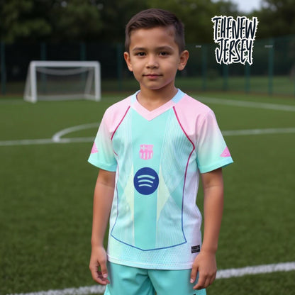 Child wearing kids football kit jersey and shorts in pink and green
