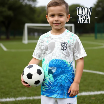 Young football player wearing Brazil inspired kids soccer kit holding a football
